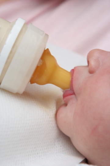 Nyfødt baby får morsmelkerstatning på flaske
