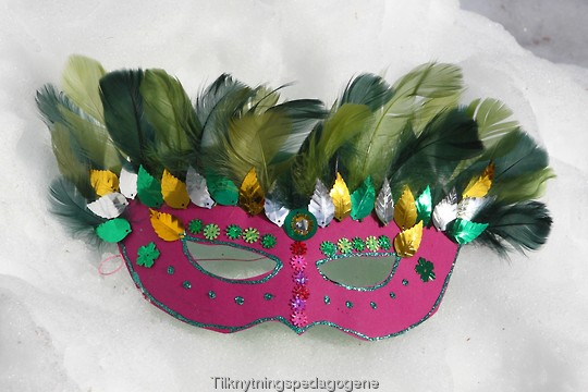 Maske laget av papir og gr��nne fj��r